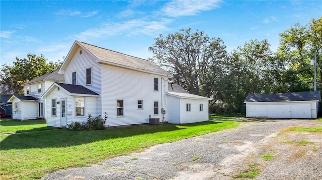 view of side of home featuring cooling unit, a lawn, and a shed