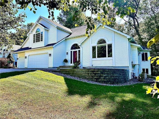 front of property with a front yard and a garage