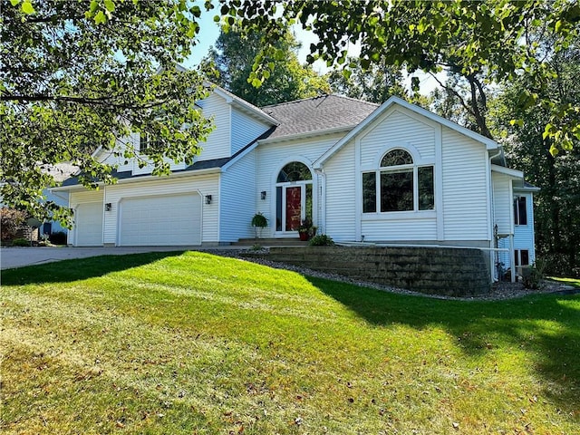 front facade with a front yard and a garage