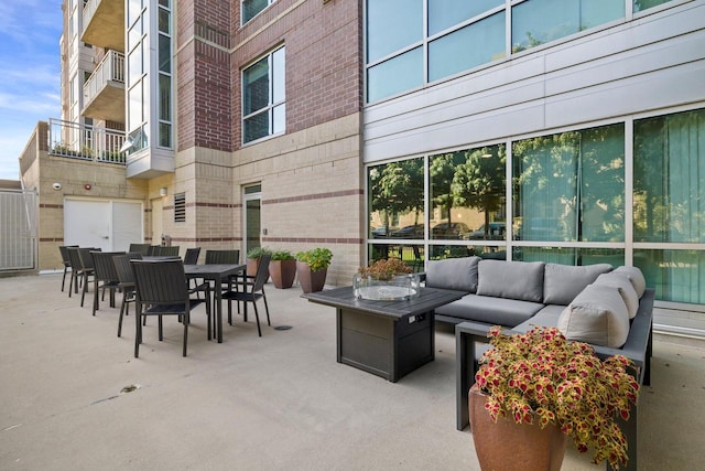 view of patio with outdoor lounge area and a balcony