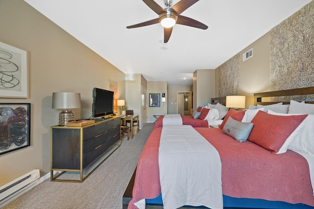 carpeted bedroom with baseboard heating and ceiling fan