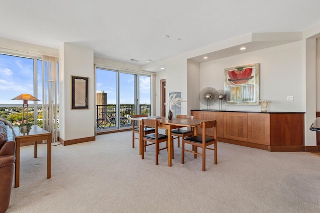 dining area with light colored carpet and a healthy amount of sunlight