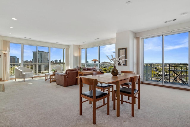 dining space featuring light colored carpet