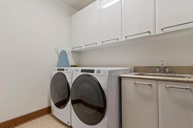 laundry area with sink, cabinets, and washer and clothes dryer