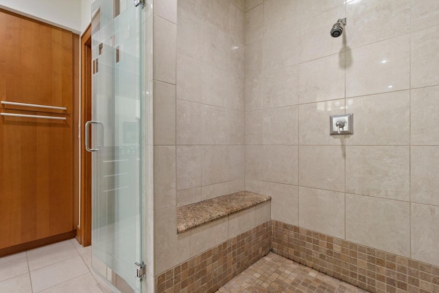 bathroom featuring tile patterned flooring and an enclosed shower