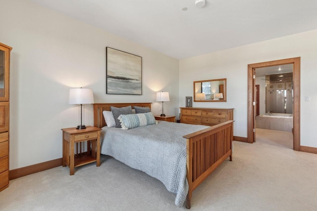 carpeted bedroom featuring ensuite bath