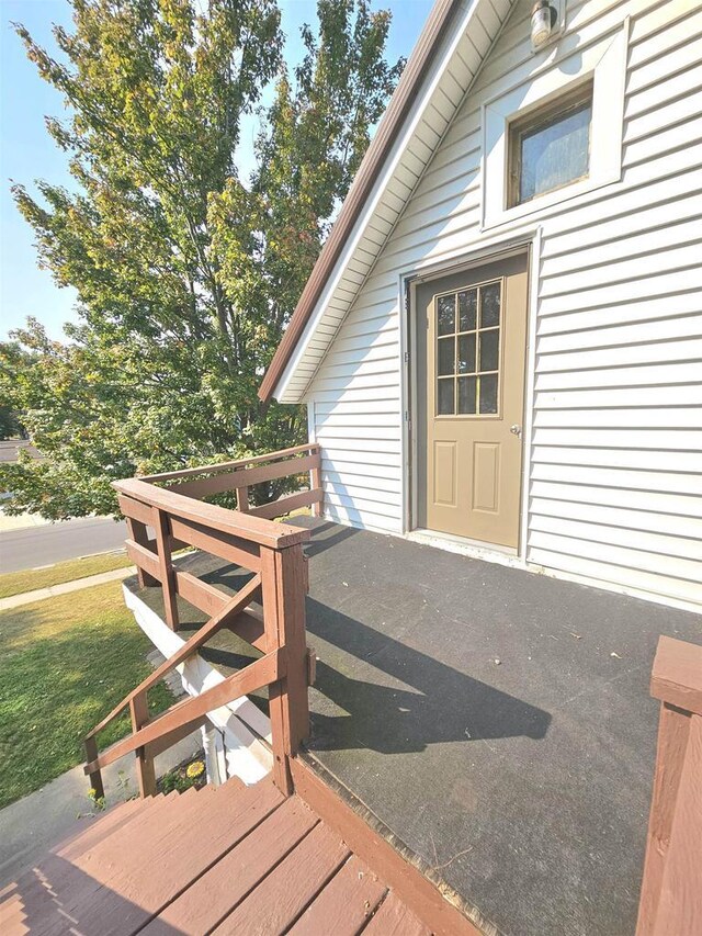 wooden terrace featuring a yard