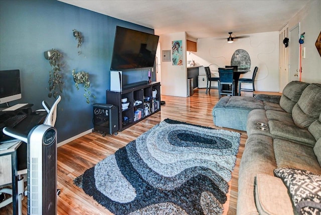 living room featuring ceiling fan and hardwood / wood-style floors