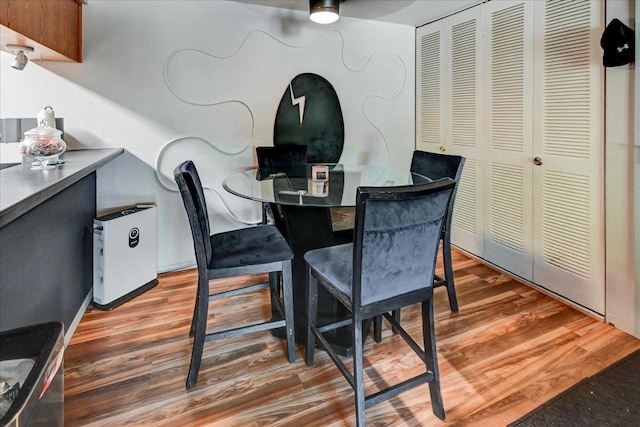 dining room with ceiling fan and hardwood / wood-style flooring