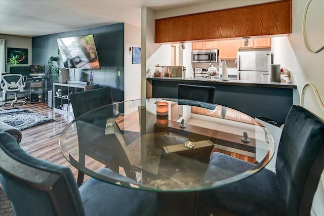 dining space featuring light wood-type flooring