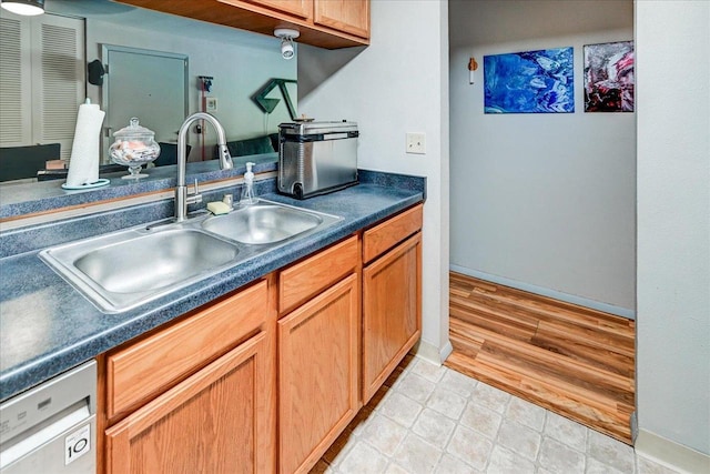 kitchen with dishwasher, light hardwood / wood-style floors, and sink