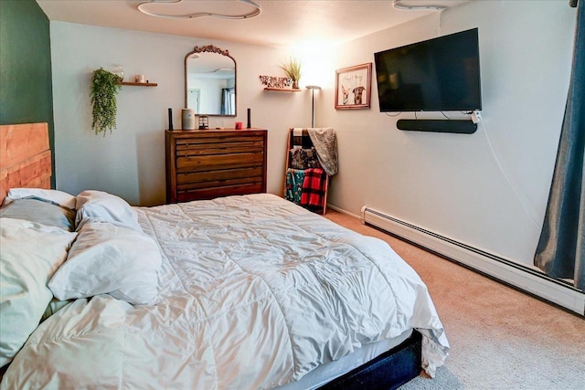 bedroom with carpet floors and a baseboard heating unit