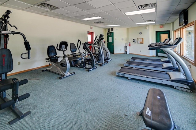 gym featuring carpet flooring and a paneled ceiling