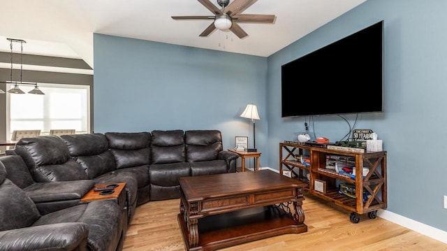 living room featuring ceiling fan and light hardwood / wood-style floors