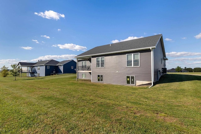 rear view of property featuring a lawn