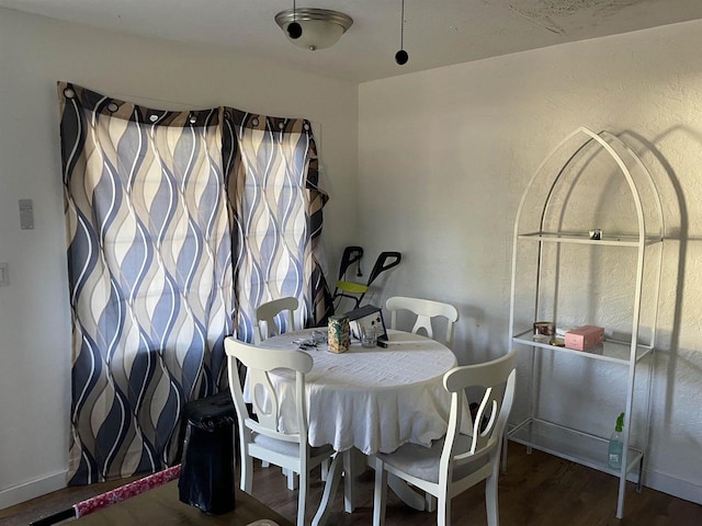 dining area with dark hardwood / wood-style flooring