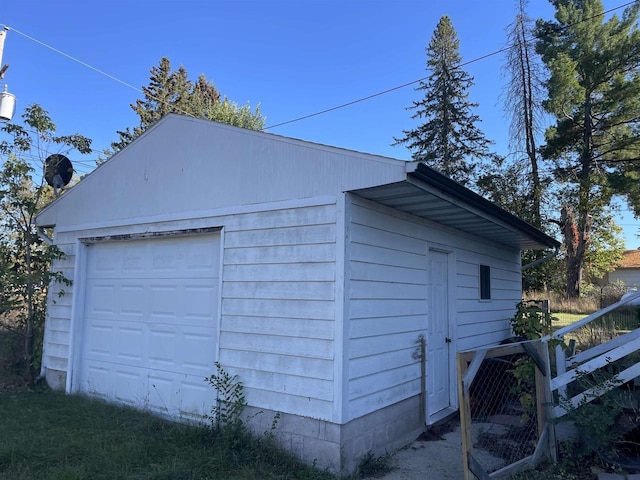 view of property exterior with a garage and an outbuilding