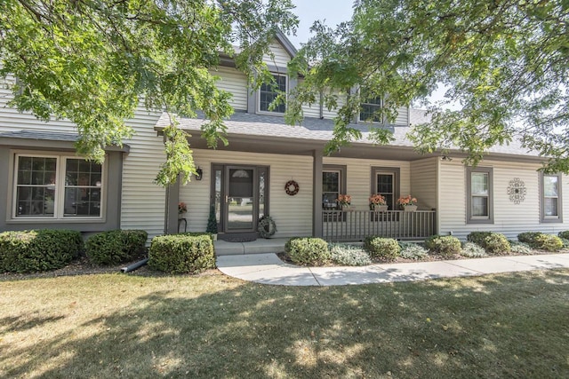 view of front of house with a porch and a front yard