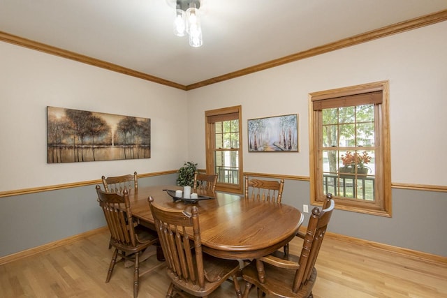 dining area featuring light wood-type flooring and ornamental molding