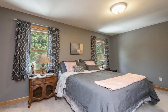 bedroom with multiple windows and carpet