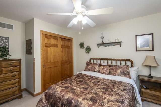 carpeted bedroom featuring a closet and ceiling fan