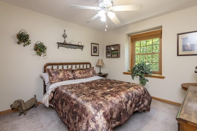 bedroom with ceiling fan and light colored carpet