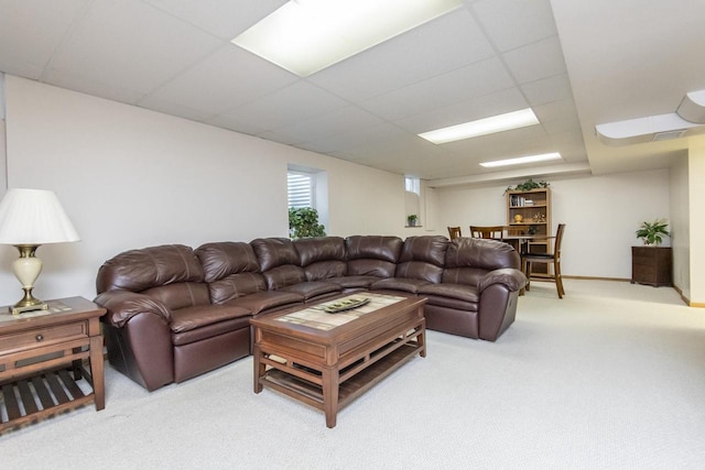 carpeted living room featuring a paneled ceiling