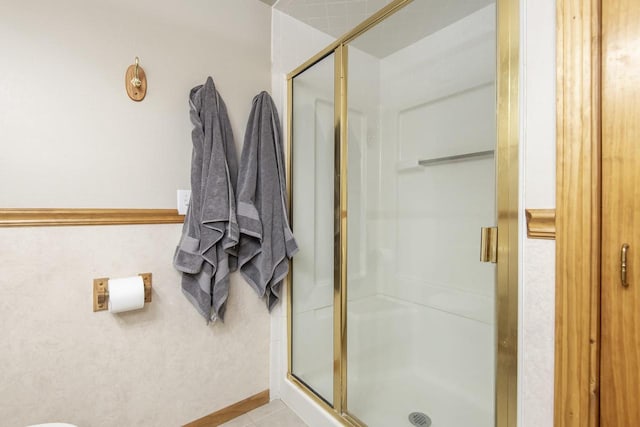 bathroom featuring an enclosed shower and tile patterned floors