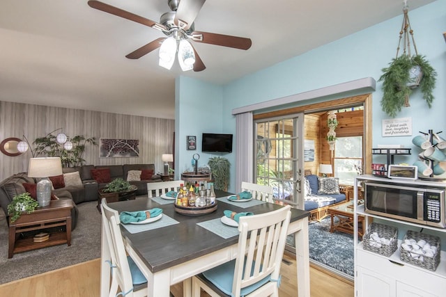 dining area featuring ceiling fan and light wood-type flooring