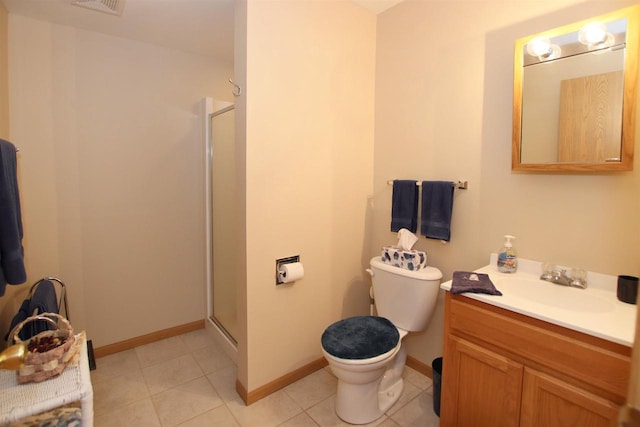 bathroom with tile patterned floors, a shower with door, vanity, and toilet