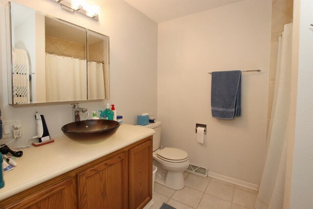 557 Highknocker Trl, Green Lake, WI 54941 - full bath featuring vanity, toilet, tile patterned floors, baseboards, and visible vents