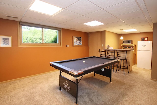 playroom with light carpet, bar, pool table, and a paneled ceiling