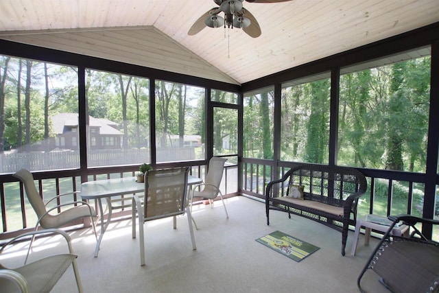 sunroom featuring wood ceiling, lofted ceiling, ceiling fan, and plenty of natural light