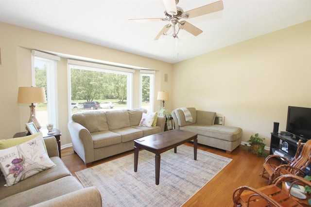 living room featuring ceiling fan, hardwood / wood-style flooring, and a wealth of natural light