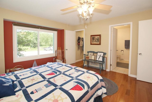 bedroom with wood-type flooring, ceiling fan, and ensuite bathroom