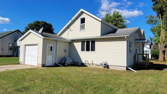 exterior space with a garage and a yard