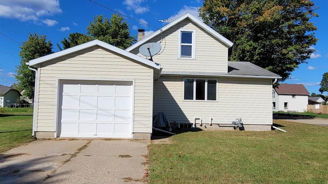 view of side of property with a garage and a yard