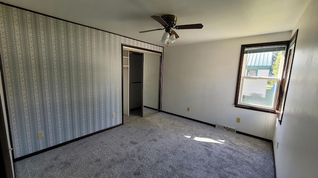 unfurnished bedroom with light carpet, ceiling fan, and a closet