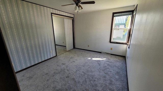 carpeted empty room with ceiling fan