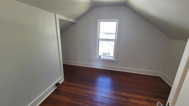 additional living space with lofted ceiling and dark wood-type flooring