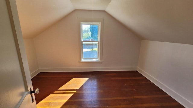 bonus room with vaulted ceiling and dark hardwood / wood-style flooring