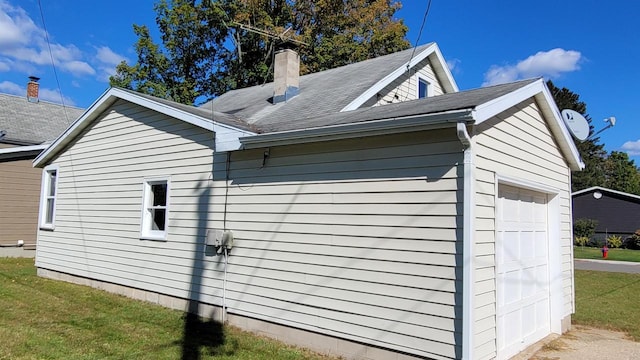 view of side of property with a garage and a yard