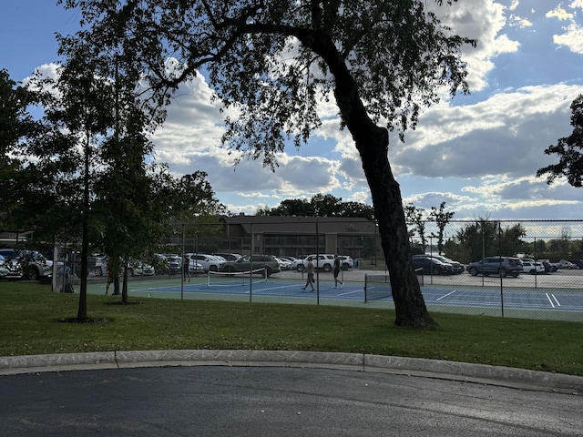 view of sport court featuring a yard