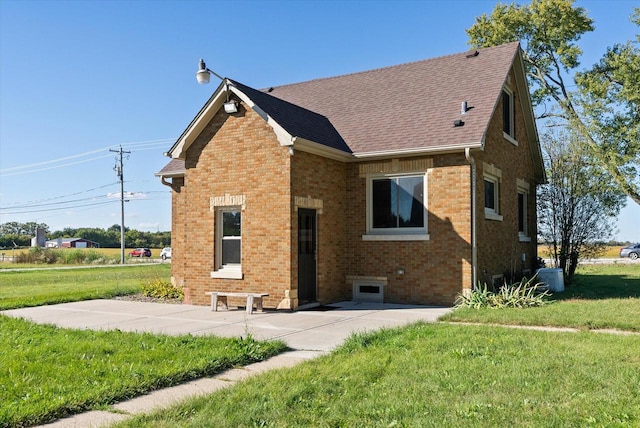 exterior space with central AC unit and a lawn