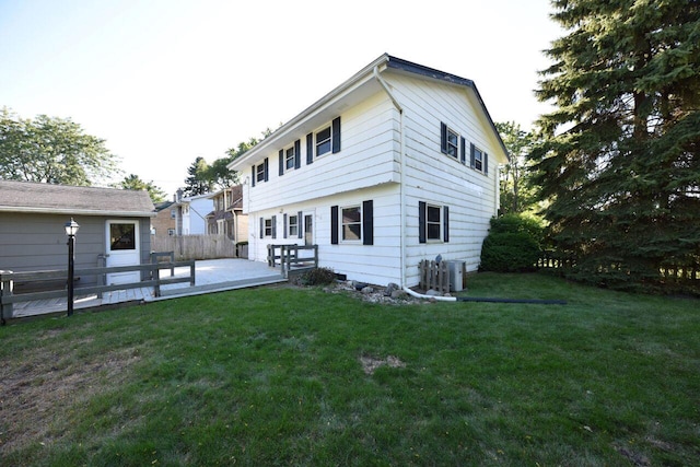 back of property with a lawn, a patio, and central AC