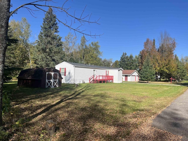 view of yard with a storage shed and a wooden deck