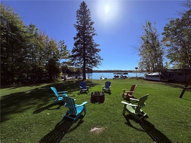 view of yard with a water view and a fire pit