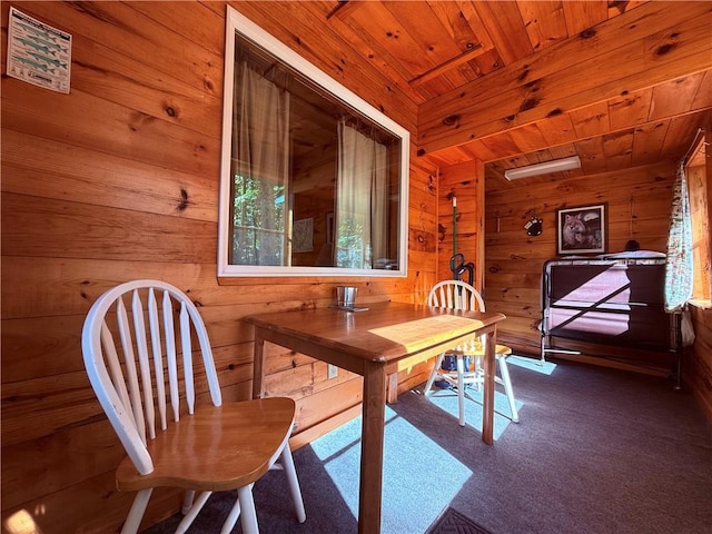 carpeted office featuring wooden walls and wood ceiling