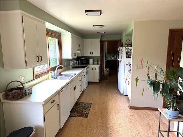 kitchen featuring white appliances, light hardwood / wood-style floors, sink, and white cabinets