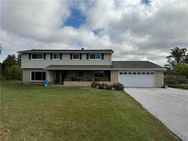 view of front of house featuring a front lawn and a garage